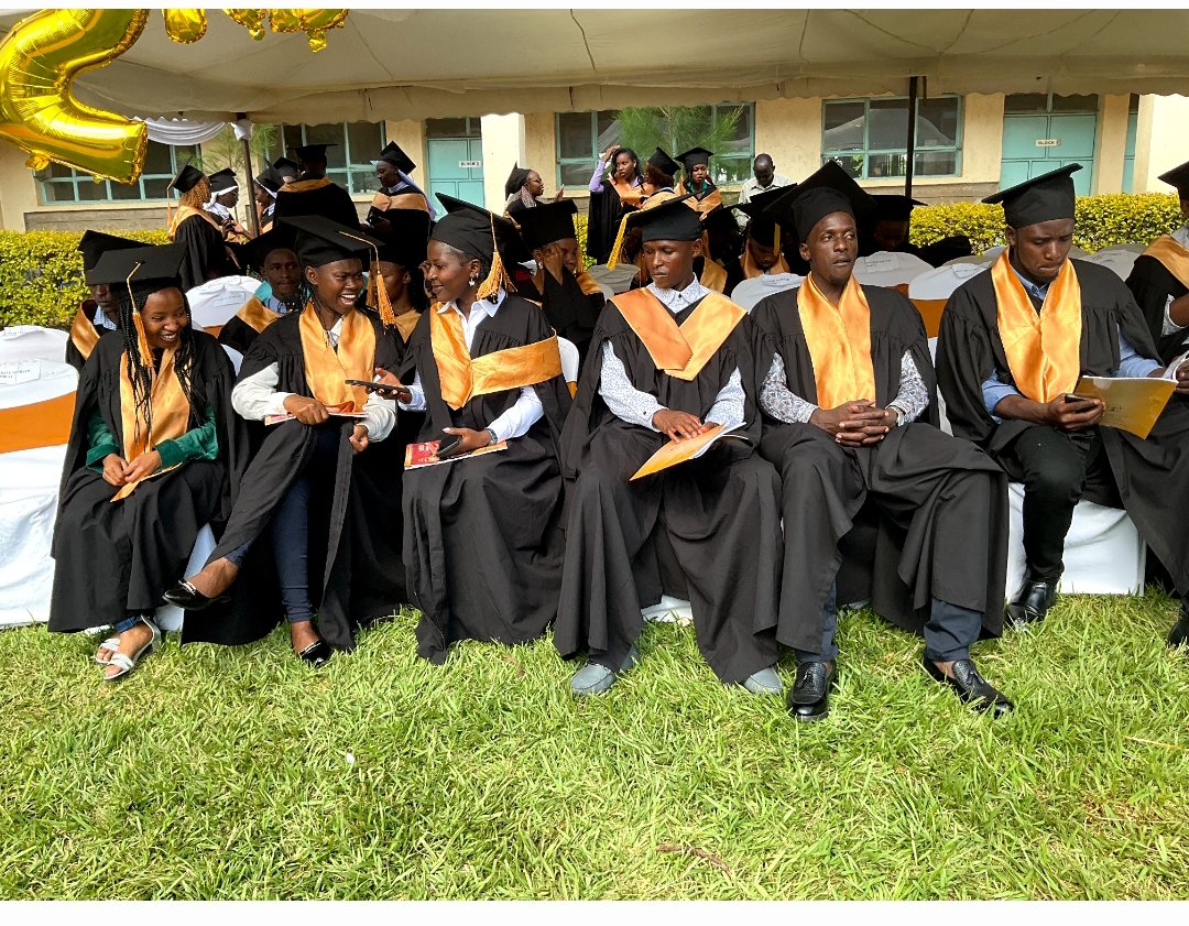 Graduands celebrating on the college lawn
