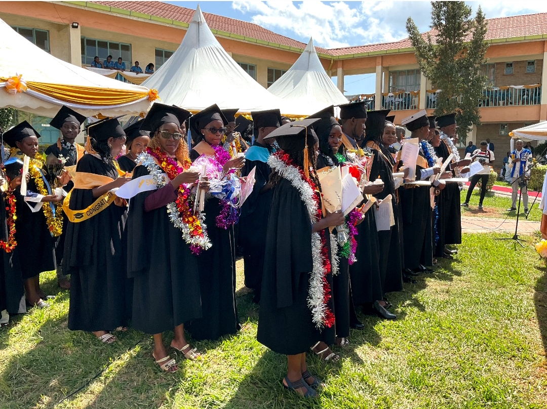 Graduands with flowers and garlands after the ceremony